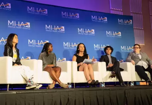 Crystal Widado and members of the Young Leaders Council sit on stage during the youth panel at conference
