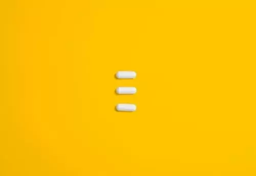 Three pills on a yellow background